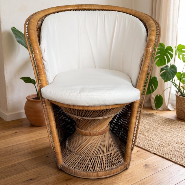 A striking and inviting tub chair, handcrafted from woven wicker, cane, and natural rattan, complete with removable light-...