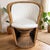 A striking and inviting tub chair, handcrafted from woven wicker, cane, and natural rattan, complete with removable light-...