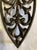This vintage Griswold cast iron trivet features an elegant scrollwork design framed in a shield-shaped form. Griswold is...