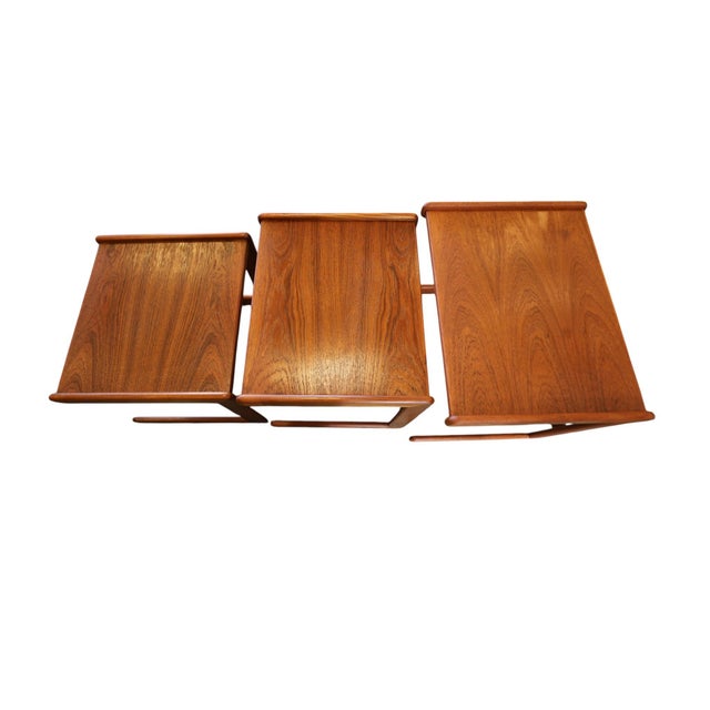 An incredibly beautiful Danish teak set table, where warm wood tones and expressive details meet a well-thought-out,...