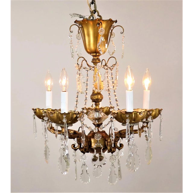 A luxurious midcentury French Louis XV style gilt brass and crystal Maison Jansen chandelier. Maison Jansen is known as...