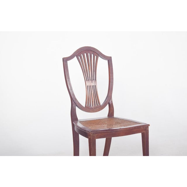 Chair with straw seat. with a shield-shaped backrest, typical of the Hepplewhite style, popular at the end of the 18th...