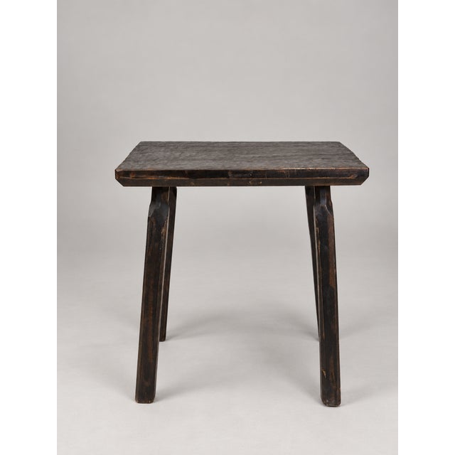 In the style of the artisans of Marolles and the Loir-et-Cher region, a blackened wood table with a honeycomb pattern...
