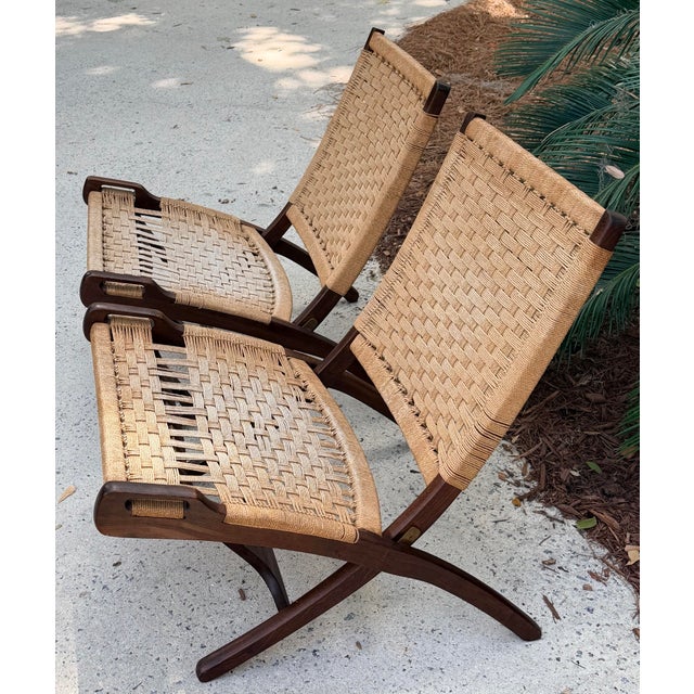 Exceptional pair of folding lounge chairs, made in Yugoslavia. While often described as in the manner of Wegner, these...