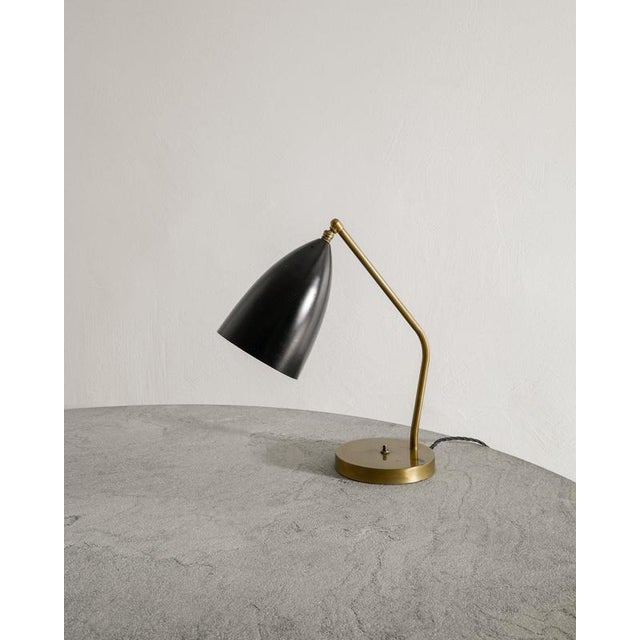 A very rare mid century "grasshopper / model 732" desk table lamp with a patinated brass foot and black lacquered...