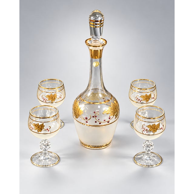 DESCRIPTION A charming vintage cordial service with a distinctly romantic character, featuring a graceful glass decanter...