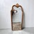 A striking vintage Hollywood Regency wall mirror featuring an elegant Rococo Revival silhouette with a sculptural arched...