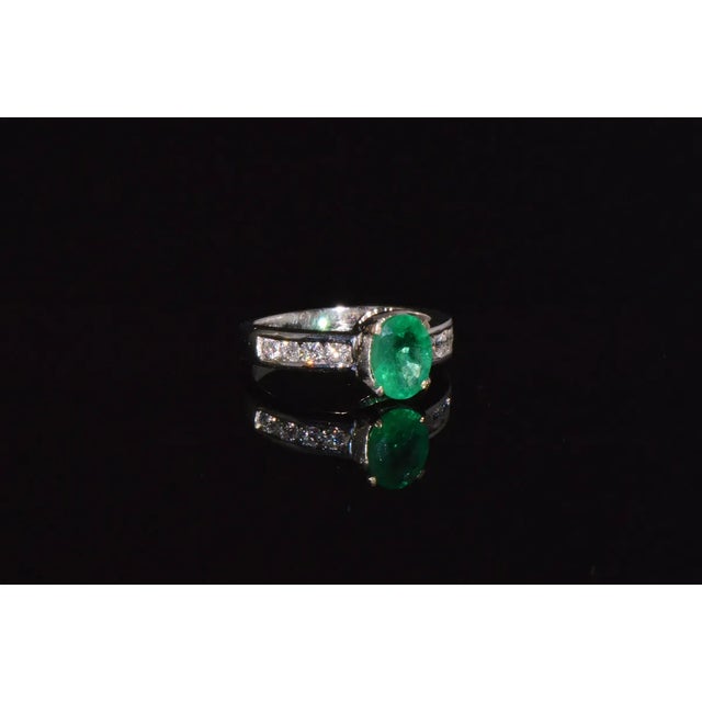 Certified 1.87CTS diamond emerald 18K solid gold ring. This ring features a large 1.30CT natural emerald. The oval...