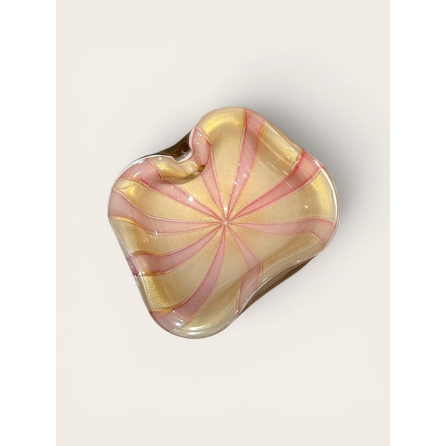 A whimsical Mid-Century Modern Murano glass bowl by Alfredo Barbini. The hand-blown freeform form features soft pink and...