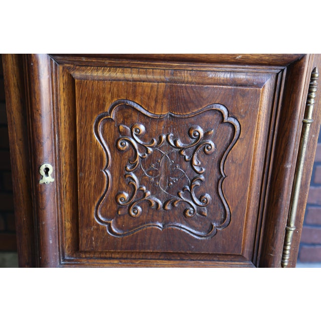 Charming antique French carved oak cabinet. Door features lovely carved detail on a raised panel and substantially sized...