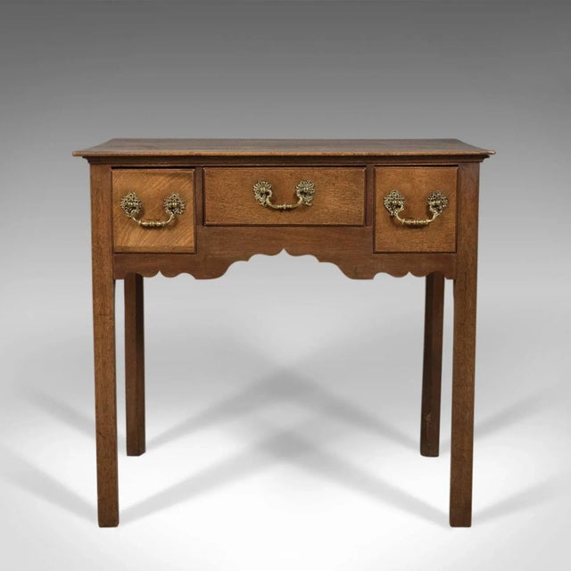 This is an antique lowboy, a mahogany, English, Victorian side table dating to circa 1900 in the Georgian taste. Grain...