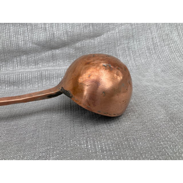 Antique polished, hand wrought, tin lined copper ladle. Long handle, beautiful patina, heavy . Ladle measures 18 1/2" by 3...