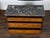 A French Directoire style walnut commode from the 19th century, with three drawers, grey marble top, brass accents and...
