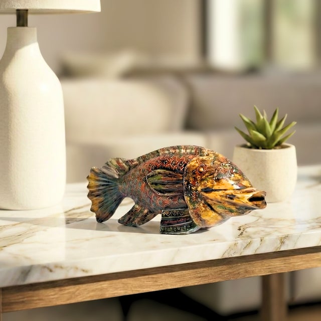 This beautiful hand carved fish has been hand painted by skilled artisan. Add a touch of color to the modern interior with...