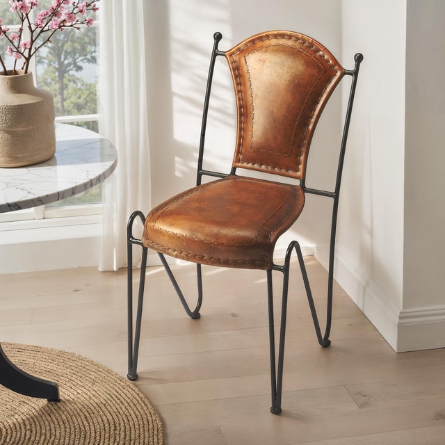 With a nimble base providing contrast to an ample, top stitched leather seat and back, this side chair is a stylish...