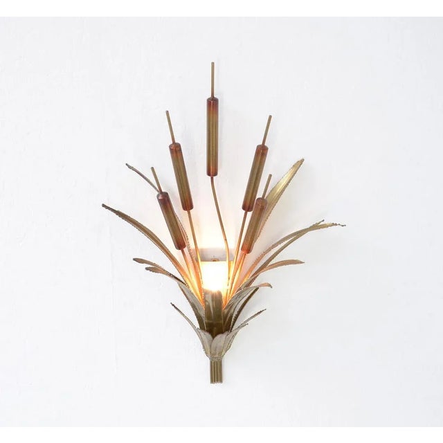 This cattail wall lamp can be attributed to Maison Jansen in Paris. It is made in the 1970s. This decorative wall lamp is...