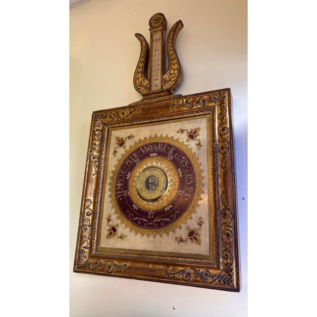 Aged 19th century ornately carved gilt wood mercury barometer. The barometer incorporates a non-operational display for...
