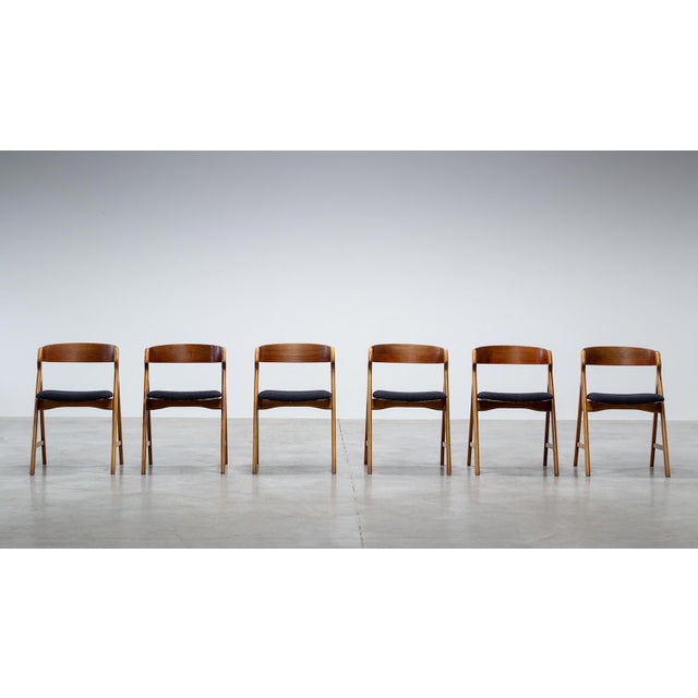 A refined example of Scandinavian craftsmanship, this set of six Model 71 dining chairs designed by Henning Kjærnulf for...