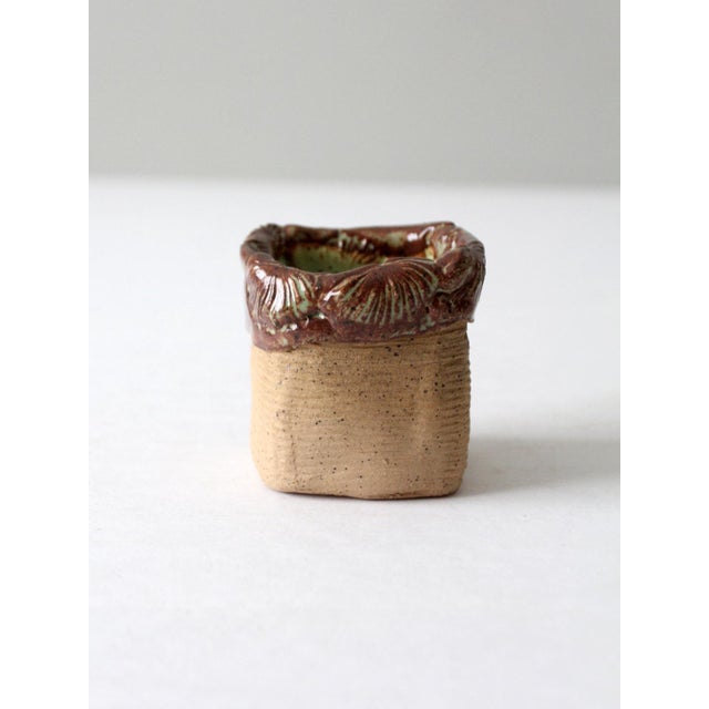 This vintage handmade studio pottery vase features a slab-built construction with a textured, earthy surface. The organic...