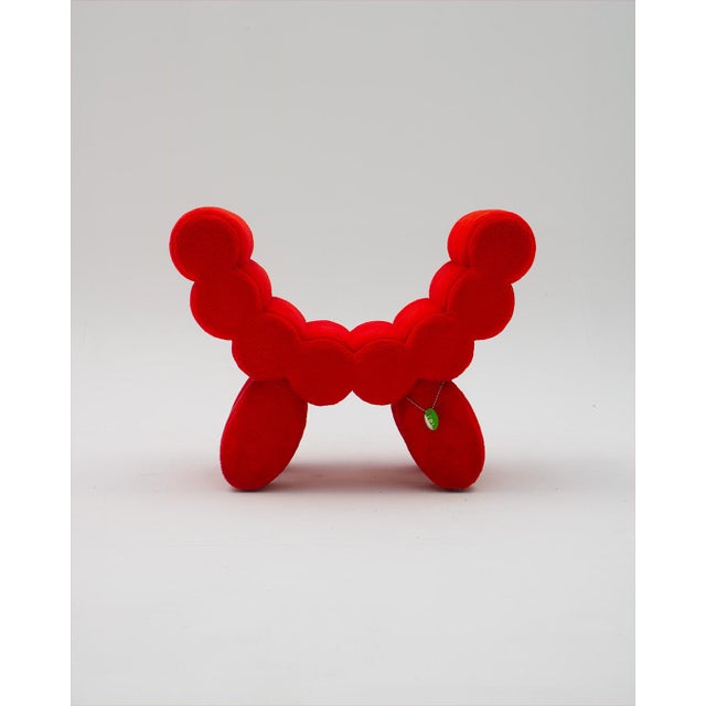 A postmodern armchair with a rare and peculiar design in red velvet, it is an armchair that serves as both a chair and...