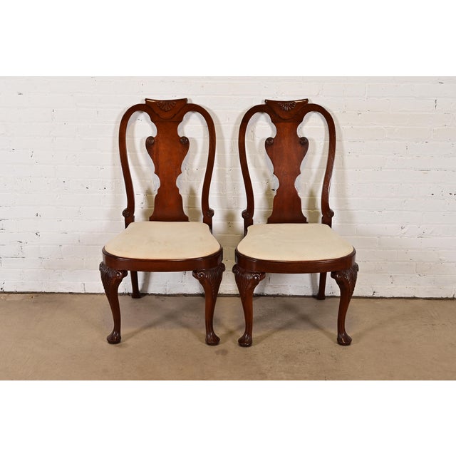 A gorgeous pair of Queen Anne or Georgian style side chairs or dining chairs By Baker Furniture USA, Circa 1980s Solid...