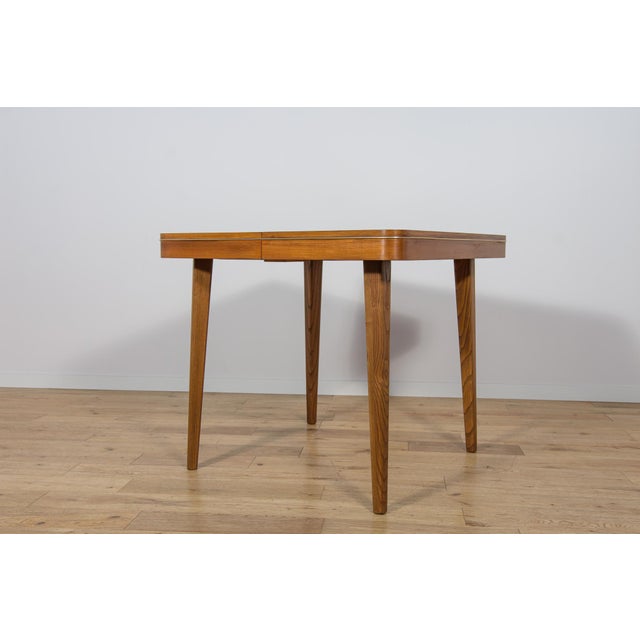 The dining table was designed in the 1950s by Bohumil Landsman and Hubert Nepozitek. It was produced in the 1960s by the...