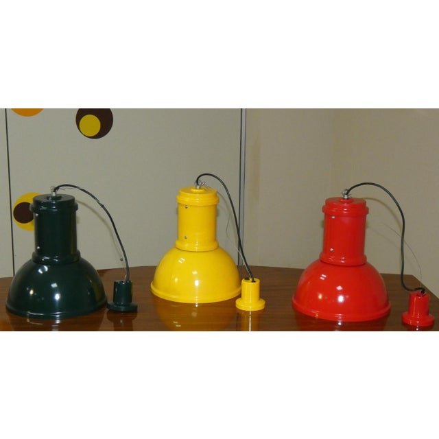 Set of 3 painted metal pendant lamps in dark green, yellow, and red, produced by Fontana Arte in the 1970s. The lamps have...