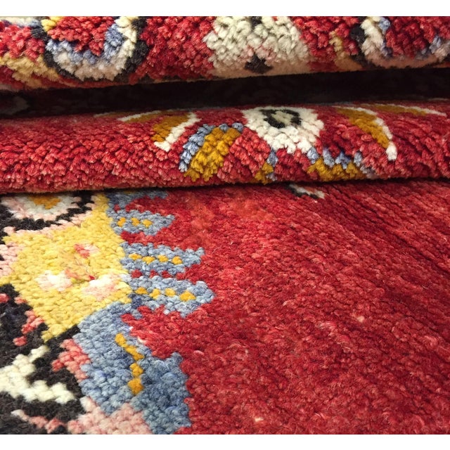 Vintage handwoven wool Turkish Oushak rug featuring a central medallion on a rich red field. Some slight wear on one end....