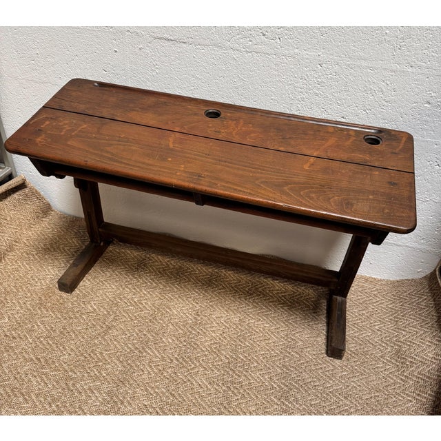 A charming antique French double school desk crafted from solid oak, dating from the early 20th century. This authentic...