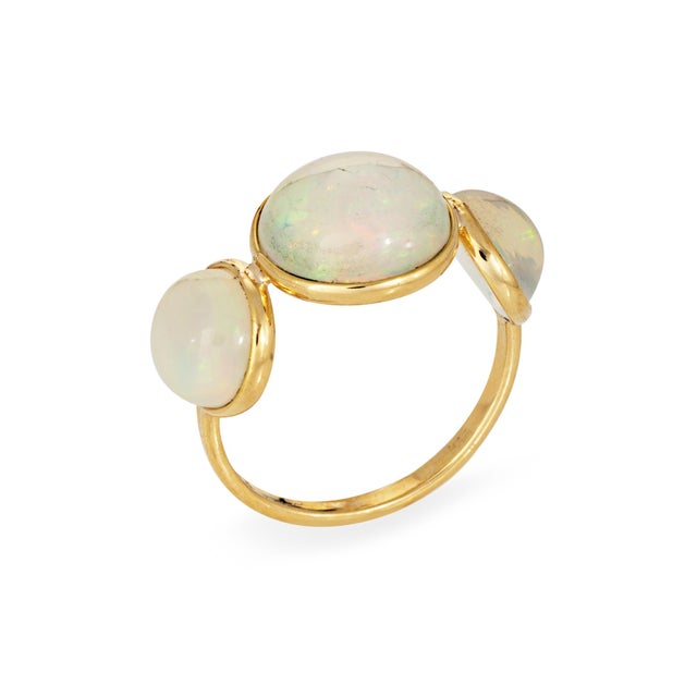 Stylish natural 3 stone opal ring crafted in 18k yellow gold. Natural opals measure from 7.5mm (two smaller opals) to...