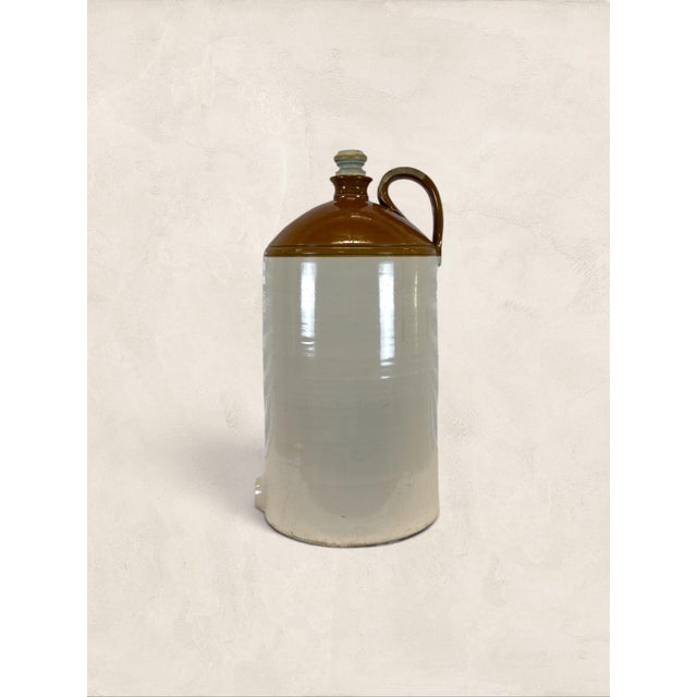 A substantial antique English stoneware water filter vessel dating to circa 1900. Finished in the traditional cream and...
