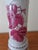 Beautiful vintage hand‑painted ceramic lamp featuring deep pink floral artwork, ribbed detailing, and warm brass accents....