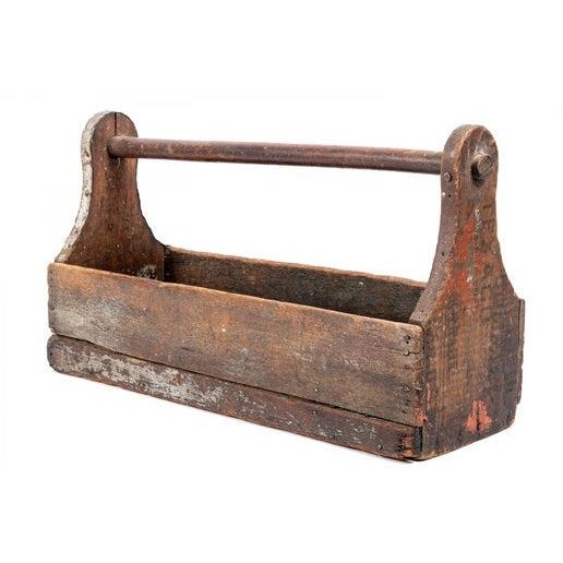 A beautifully rustic vintage wood toolbox with a dark brown finish, displaying five compartments in a rectangular box with...