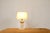 Mid-century travertine table lamp, 70's. Owl shaped travertine foot with a beige hood and gold finish details. In overall...