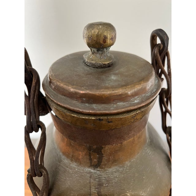 Unique copper water or oil vessel. Great lines and visual impact. Urn shape with lidded top. Heavy chain and hook for...