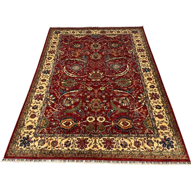 This Bijar Persian design rug has a deep red field filled with flowers, curved vines, and large decorative blooms. Navy,...