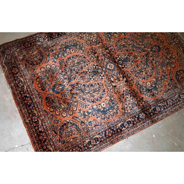 Handmade antique Persian Sarouk rug in original condition, it as some age wear on one corner. The rug is from the...