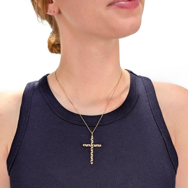 A fine antique gold, diamond, and pearl pendant cross for a necklace. In 14 karat yellow gold. In the form of a cross...