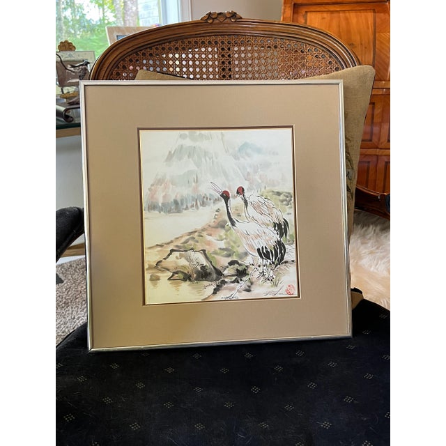 Beautiful Red Crown Crane painting in a very usable size. New non-glare glass installed in original vintage metal frame.