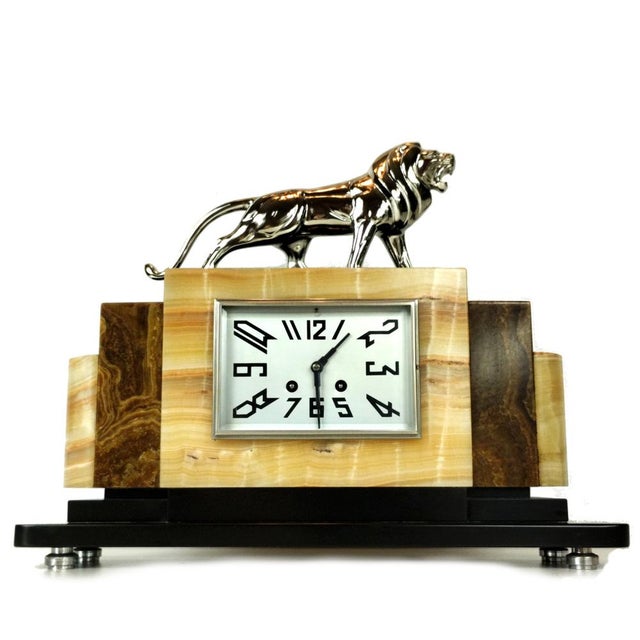 This striking French mantel clock from the 1930s stands out as a premier example of high-end Art Deco design and...