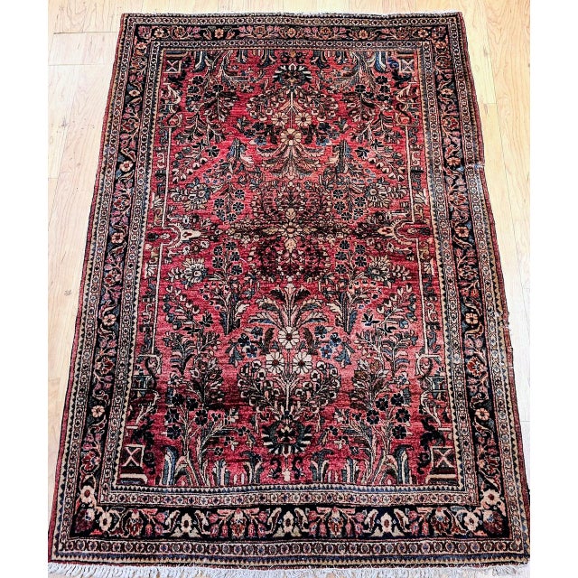 "An exceptional antique Persian Sarouk rug from the first quarter of the 20th century, handwoven with remarkable...