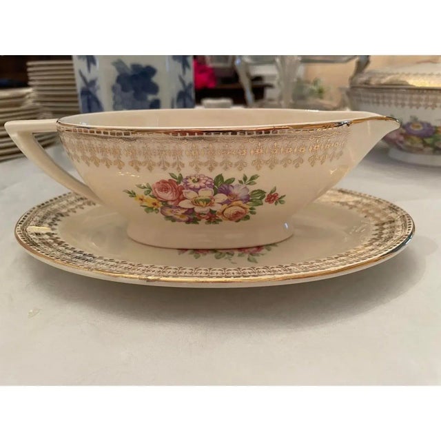Offered is a lovely vintage gravy bowl and saucer set by The Edwin M Knowles China Co. This set features a floral design...