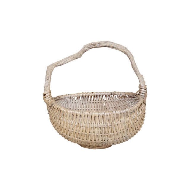 A rustic wicker rattan ‘buttock’ gathering basket, so named for the shape of the basket viewed from one side. A wooden...
