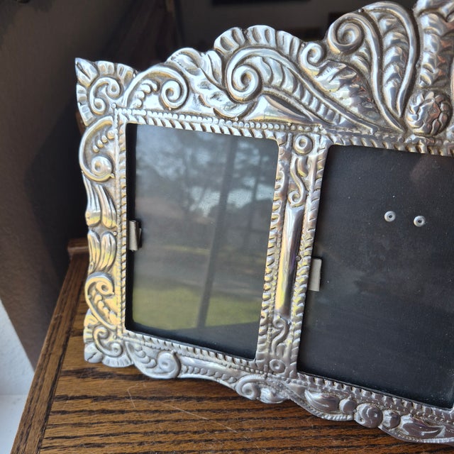 This handcrafted Mexican pewter triple triptych photo picture frame features a folk art style with an ornate design and a...