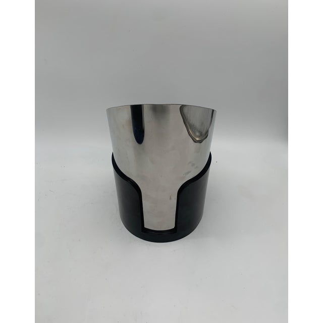 This pair of vintage-design wall lamps features a sturdy, glossy black plastic cylinder, slightly hollowed out at the top...