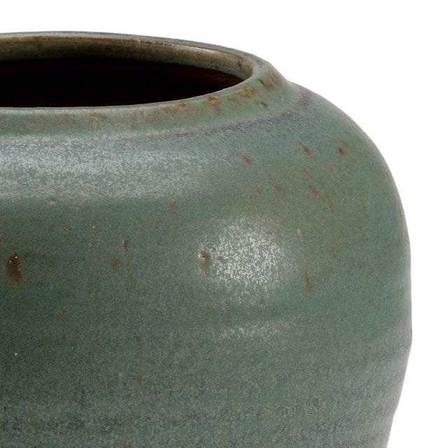 Hand finished ceramic planter in mottled green finish. For decorative use only. Color may vary