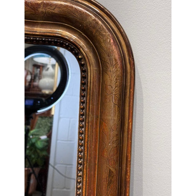 This 19th Century French mirror with camel hump top is top of its class! With its stunning gilt wood hand carved edging...