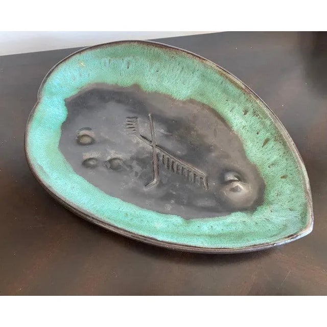 A beautiful 1940s asymmetrical leaf platter made by American studio potter, Mariana van Allesch. Signed. Biography:...