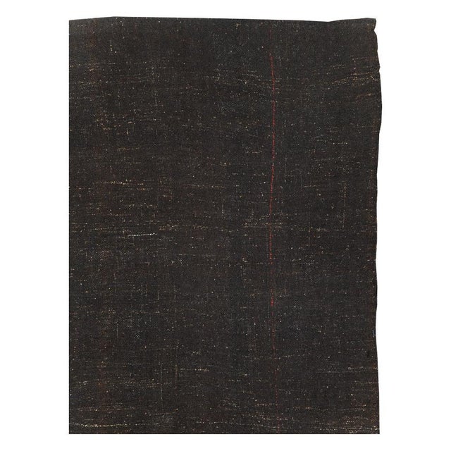 A vintage Turkish flat-weave Kilim room size carpet handmade during the mid-20th century with a Minimalist design over a...
