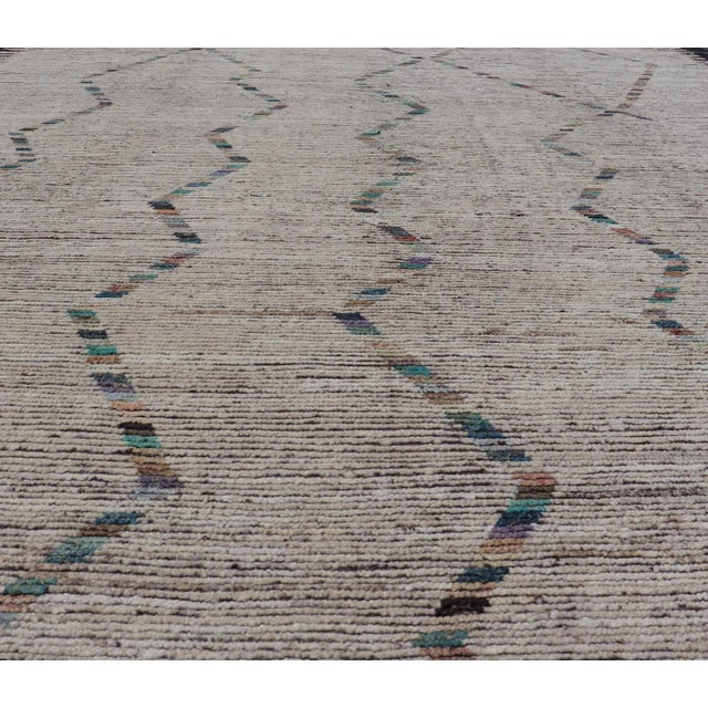 Measures: 9'0 x 12'0 This modern casual tribal design Moroccan inspired rug has been hand-knotted in wool. The rug...